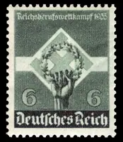 hand holding wreath & swastika